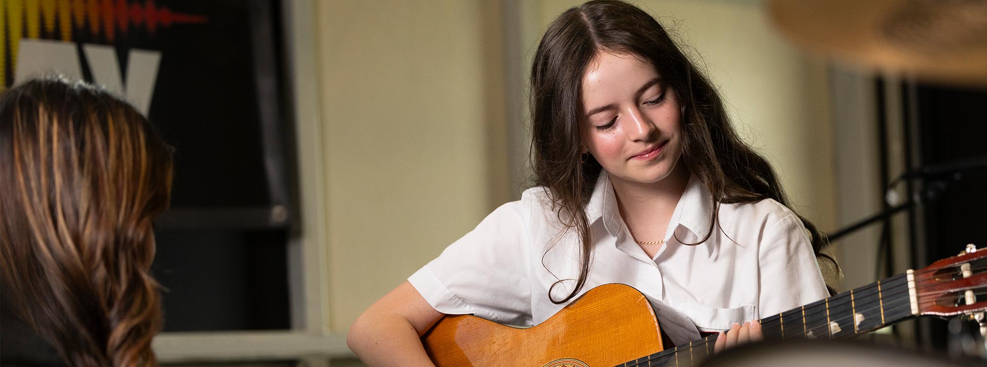 St Clare's Hassall Grove student playing guitar