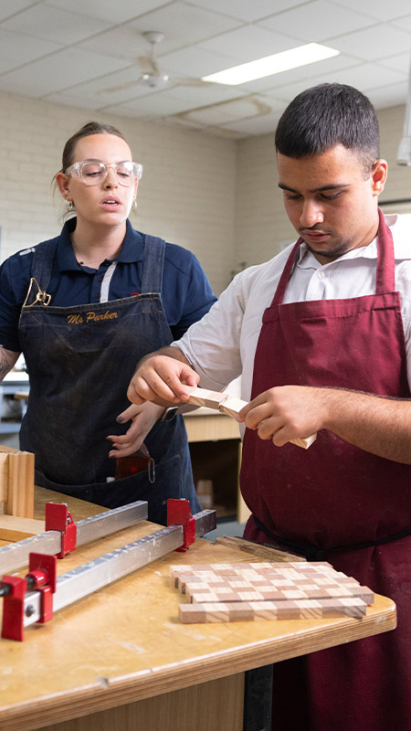 St Clare's Hassall Grove woodwork teacher assisting her students