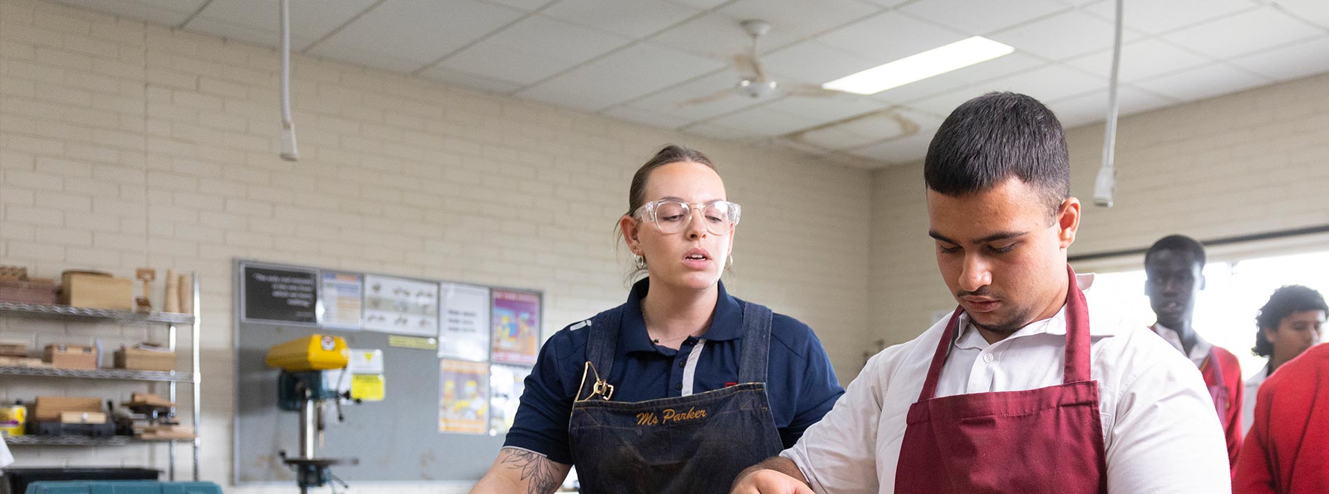 St Clare's Hassall Grove woodwork teacher assisting her students