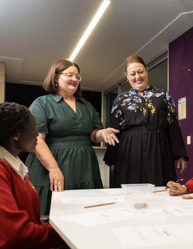 Two St Clare's teachers addressing their students