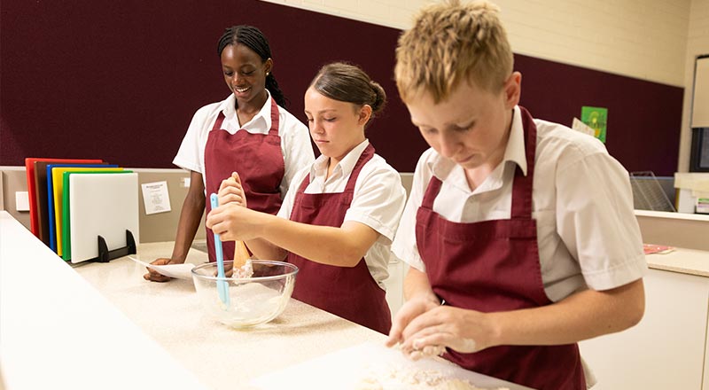 St Clare's Hassall Grove students making a dough in the food tech classroom
