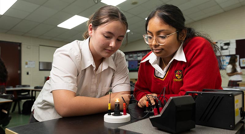 St Clare's Hassall Grove students performing experiment in science lab