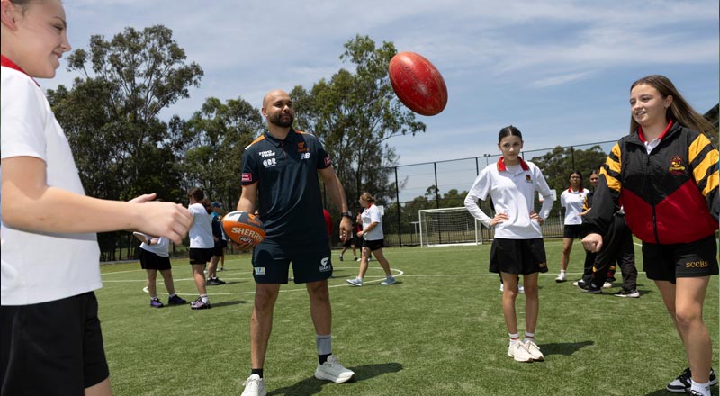Omar Elrayes, Community Manager for GWS Giants, playing AFL with St Clare's Hassall Grove students 