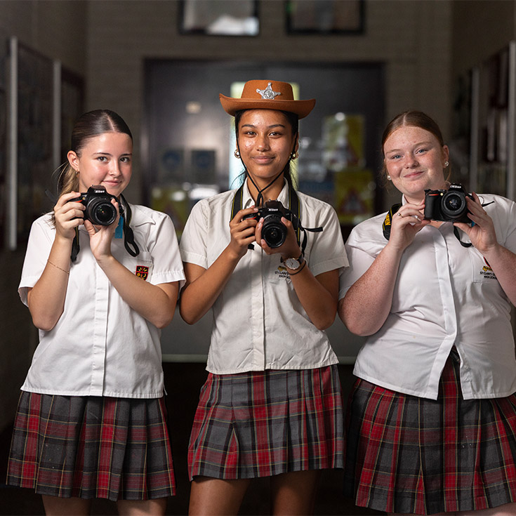 St Clare's Photography students holding DSLR cameras and wearing costumes